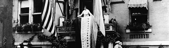 Alice Paul rolls out a victory banner on August 18, 1920 when the 19th Amendment was formally adopted. FlagandBanner.com offers flags and more to keep the Women's Equality Movement going.