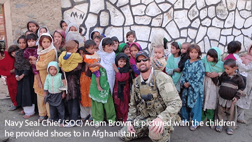 Adam Brown with the children he provided shoes